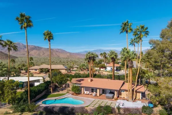 an aerial view of a house a garden and swimming pool