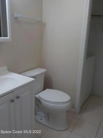 a white toilet sitting next to a white sink
