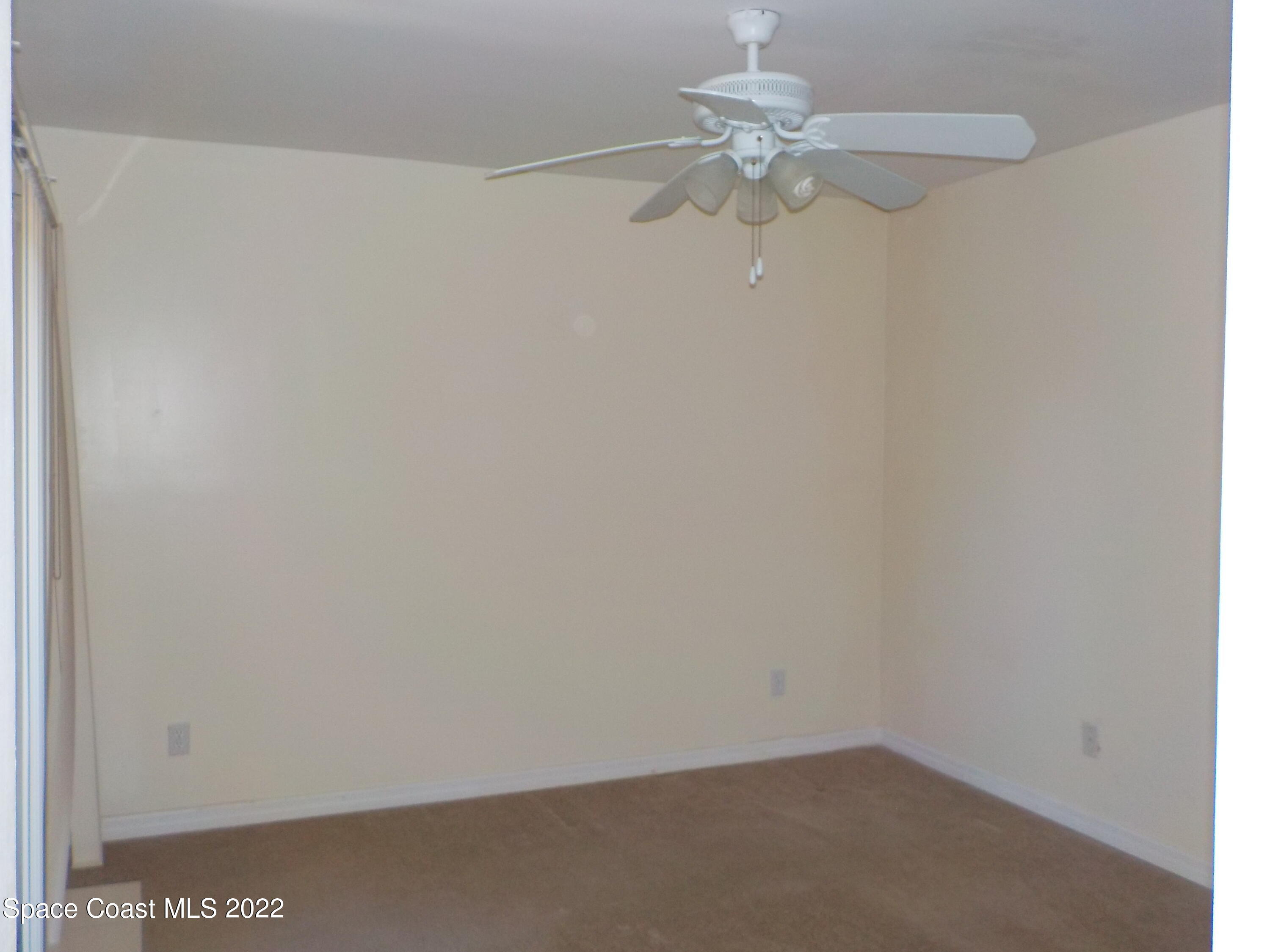 3218 Vista Oaks Circle Northeast Palm Bay, FL 32905 - Photo 9 of 11 a view of a small space with a chandelier fan