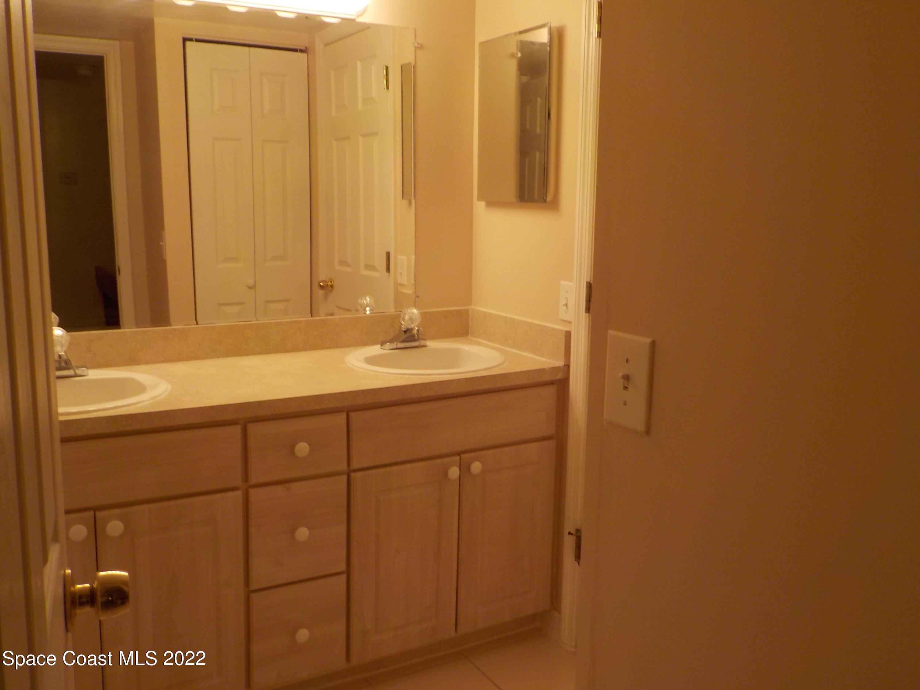 3218 Vista Oaks Circle Northeast Palm Bay, FL 32905 - Photo 10 of 11 a bathroom with a sink and a mirror