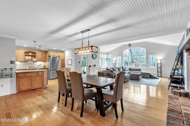 a large kitchen with a table and chairs