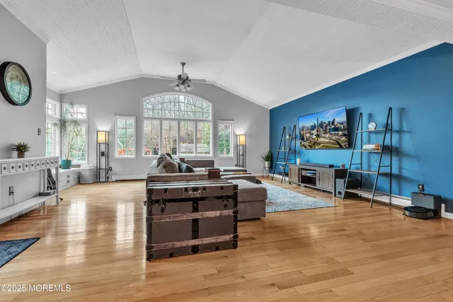 a living room with furniture a large window and a clock