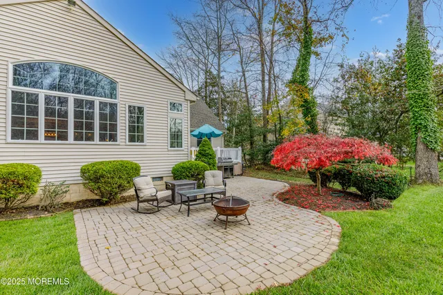 a backyard of a house with table and chairs