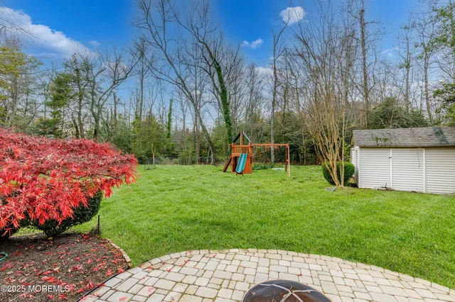a view of a backyard with table and chairs and potted plants