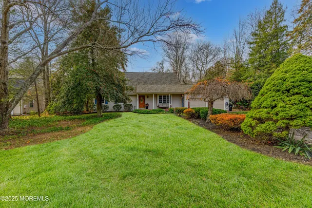 a view of house with a yard