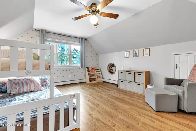 a bedroom with furniture and a large window
