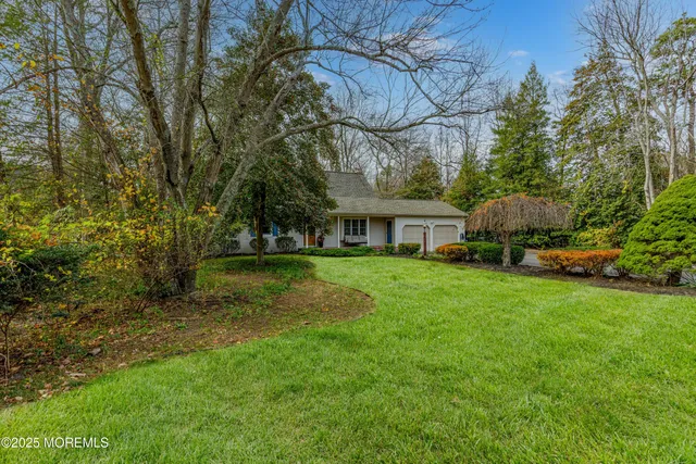 a view of house with yard and outdoor seating