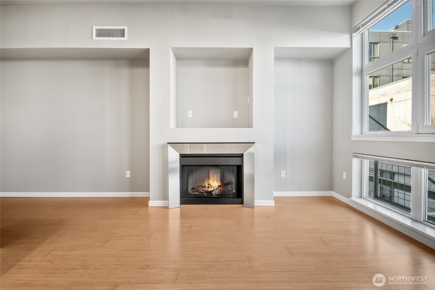 17 West Mercer Street, Unit 217 Seattle, WA 98119 - Photo 13 of 36 a view of an empty room with a fireplace and a window
