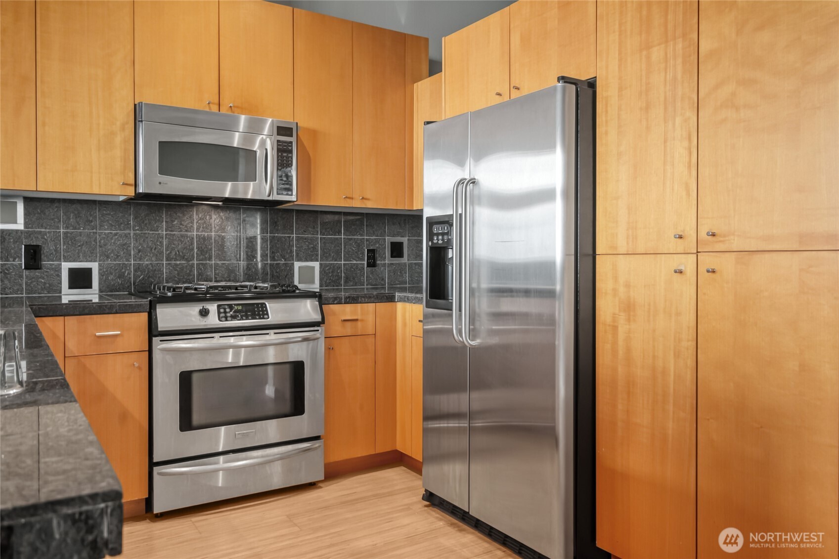 17 West Mercer Street, Unit 217 Seattle, WA 98119 - Photo 18 of 36 a kitchen with a refrigerator stove and microwave