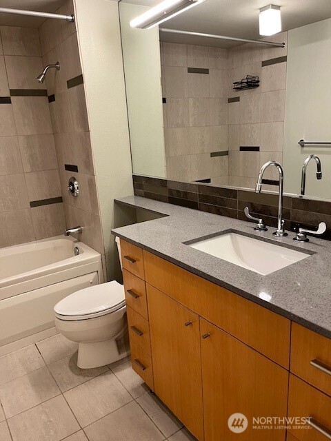 17 West Mercer Street, Unit 217 Seattle, WA 98119 - Photo 26 of 36 a bathroom with a granite countertop sink toilet and shower