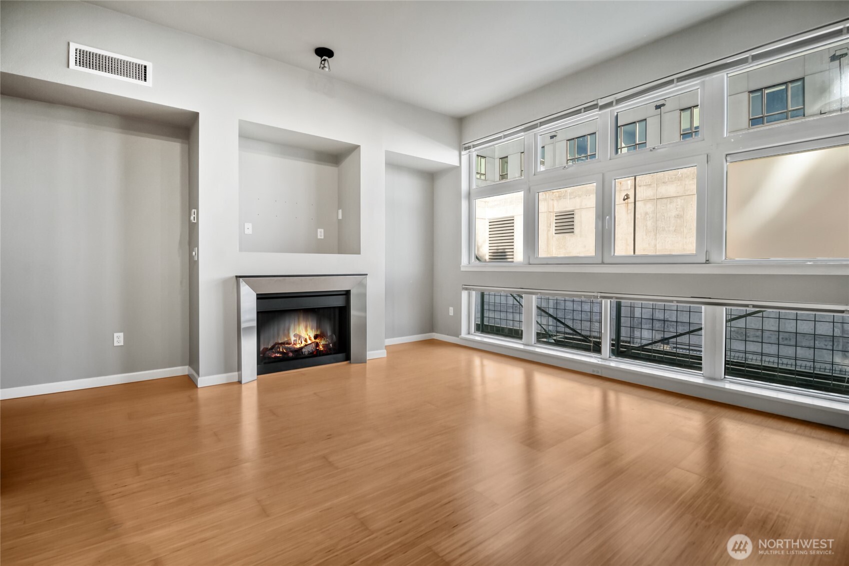 17 West Mercer Street, Unit 217 Seattle, WA 98119 - Photo 9 of 36 a view of a livingroom with wooden floor and a fireplace