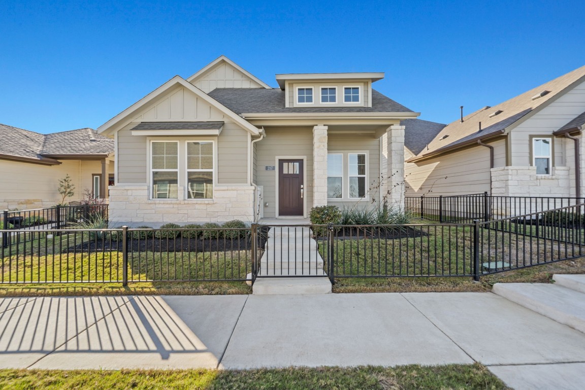 a front view of a house with a garden