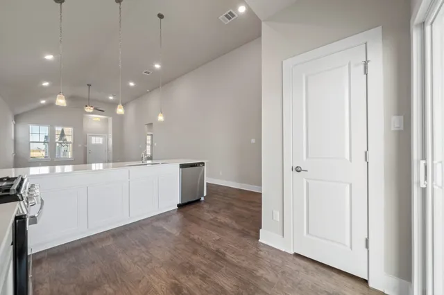 a large white kitchen with a large window