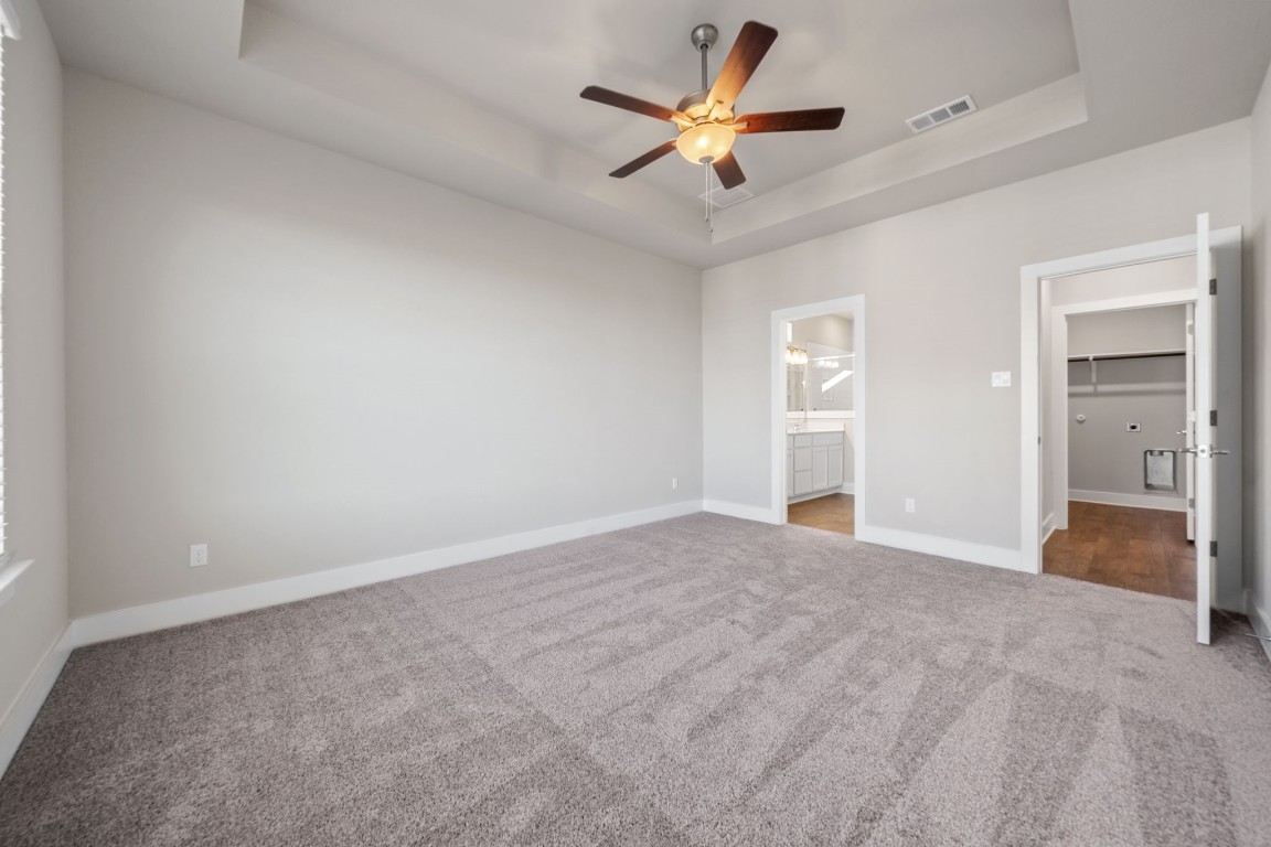 217 Pinnacle Lane Kyle, TX 78640 - Photo 15 of 33 an empty room with fan and a ceiling fan