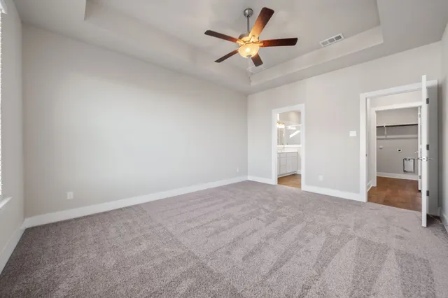 an empty room with fan and a ceiling fan