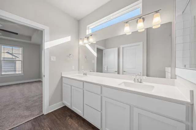 a bathroom with a double vanity sink mirror and