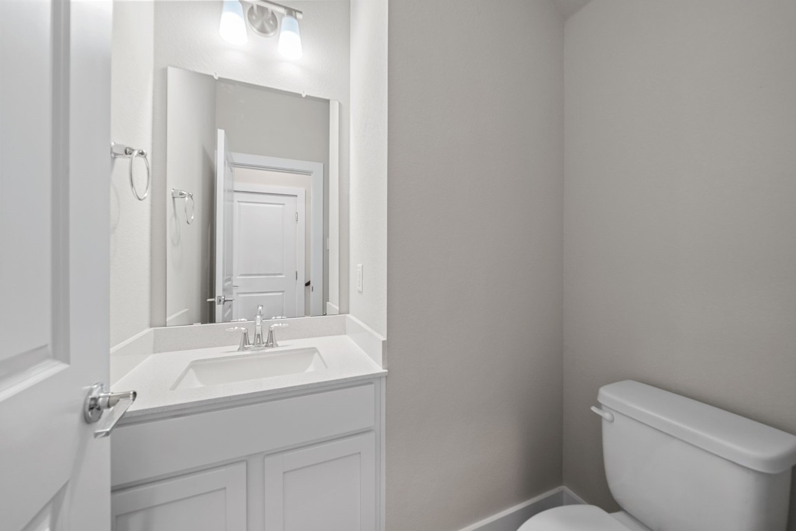 217 Pinnacle Lane Kyle, TX 78640 - Photo 21 of 33 a bathroom with a sink toilet and mirror