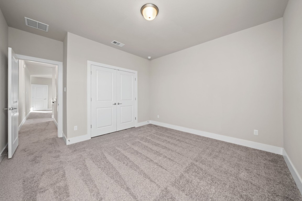 217 Pinnacle Lane Kyle, TX 78640 - Photo 27 of 33 an empty room with closet and windows