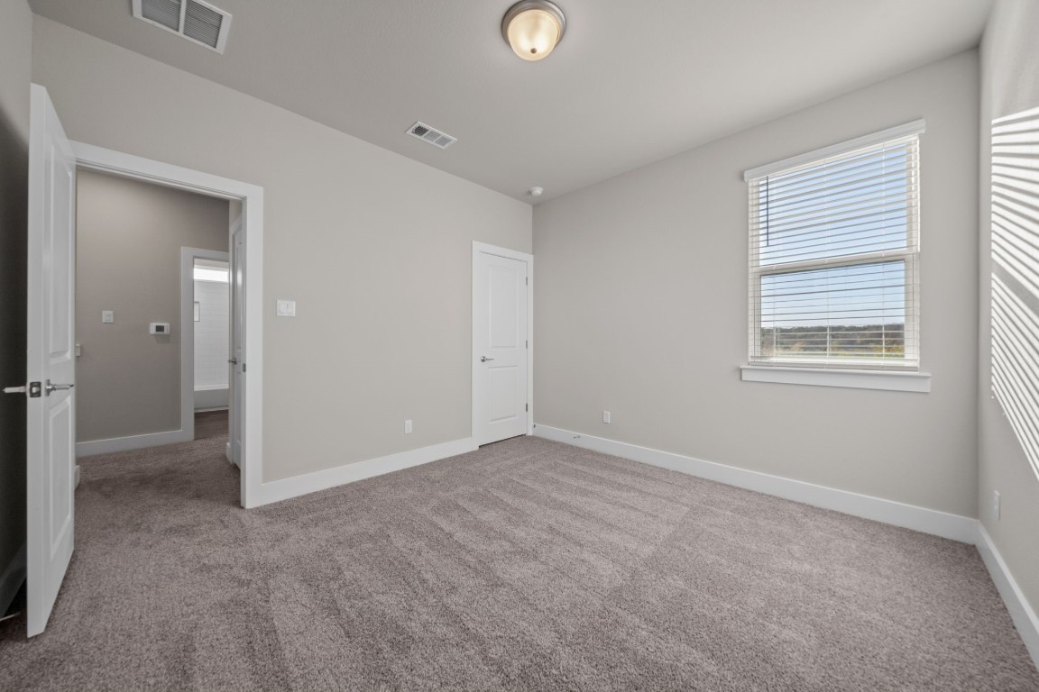 217 Pinnacle Lane Kyle, TX 78640 - Photo 29 of 33 an empty room with windows and closet