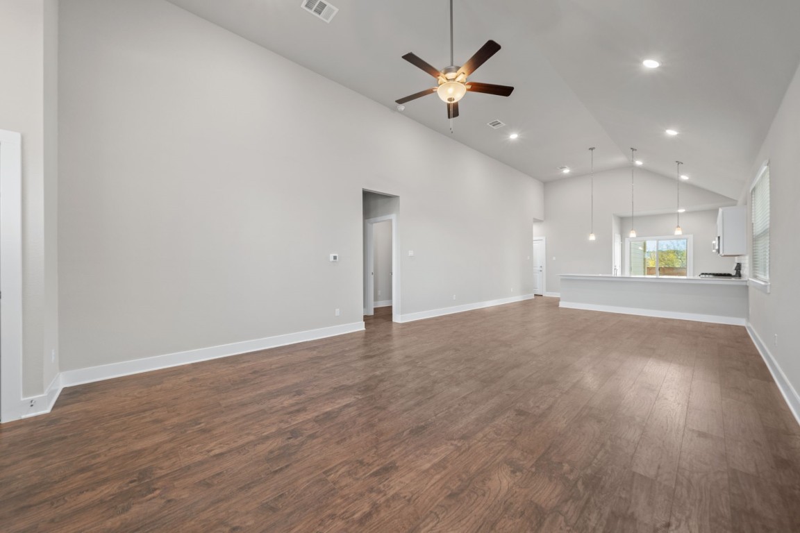 217 Pinnacle Lane Kyle, TX 78640 - Photo 4 of 33 an empty room with wooden floor and windows