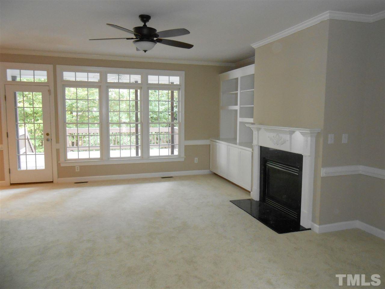 7900 Oneal Road Raleigh, NC 27613 - Photo 4 of 25 a view of an empty room with a fireplace and a window