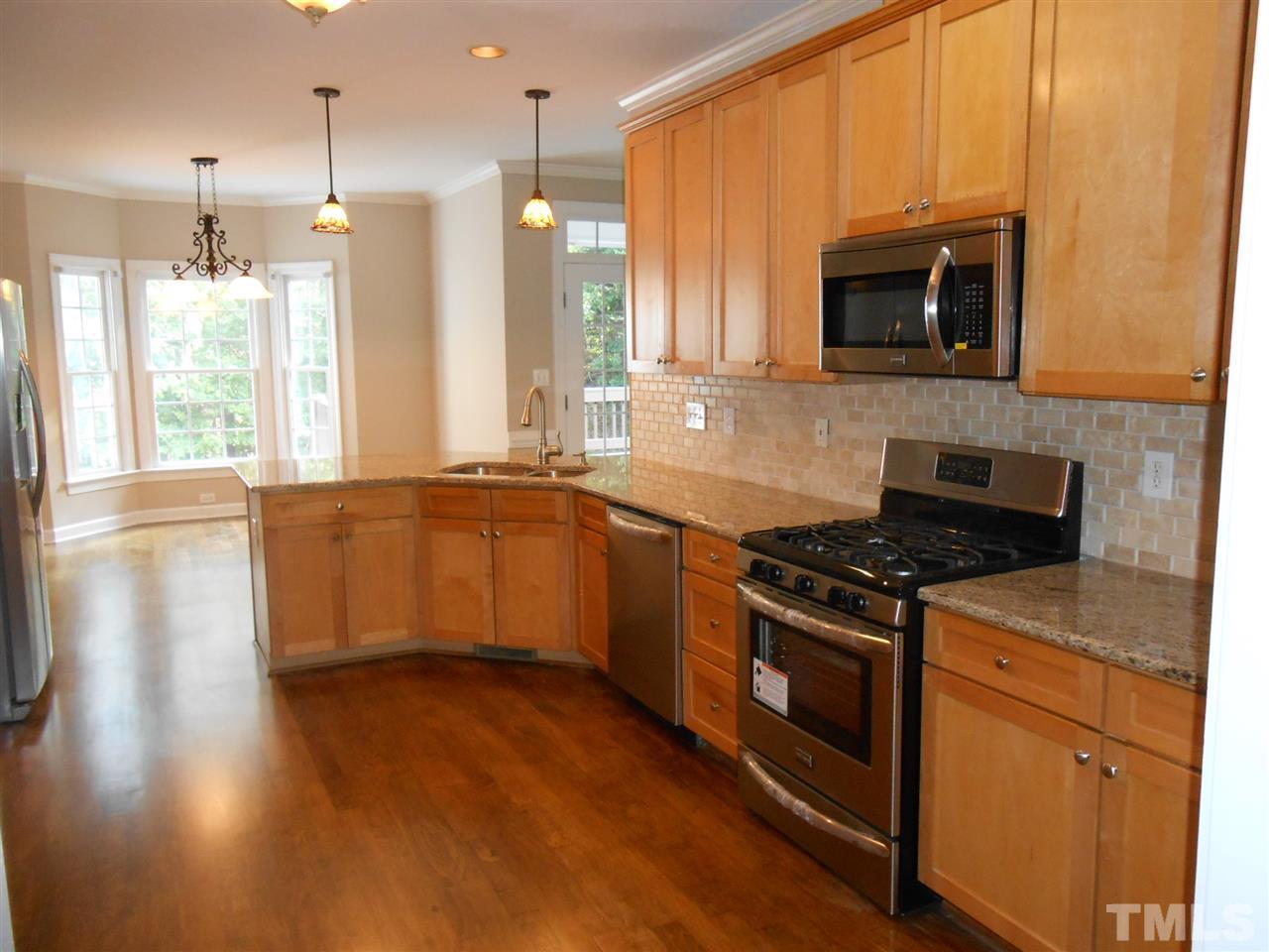 7900 Oneal Road Raleigh, NC 27613 - Photo 5 of 25 a kitchen with stainless steel appliances granite countertop a stove a sink and a microwave