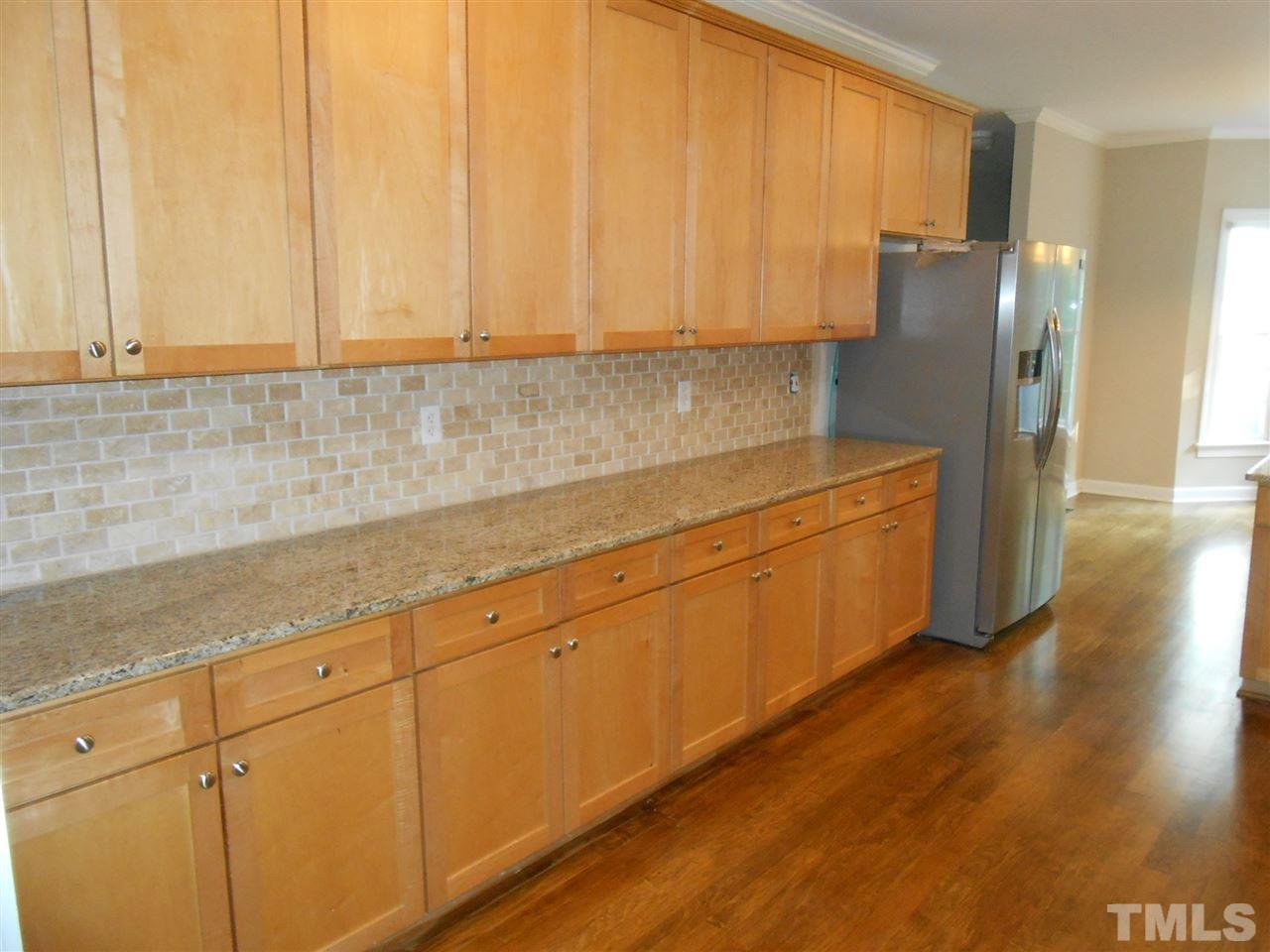 7900 Oneal Road Raleigh, NC 27613 - Photo 6 of 25 a kitchen with stainless steel appliances granite countertop white cabinets and a refrigerator