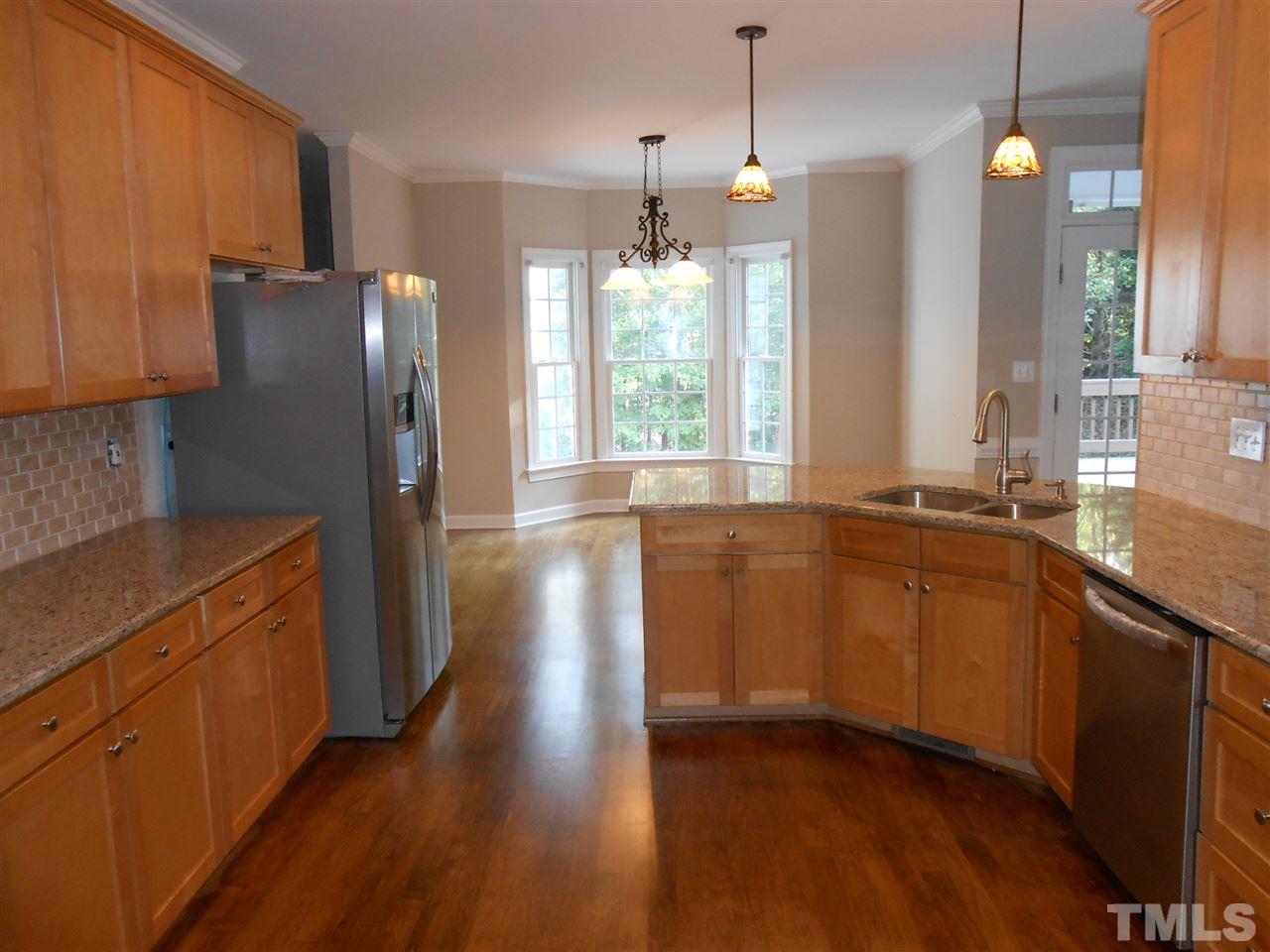 7900 Oneal Road Raleigh, NC 27613 - Photo 7 of 25 a kitchen with stainless steel appliances granite countertop a refrigerator a sink dishwasher a stove and white countertops with wooden floor