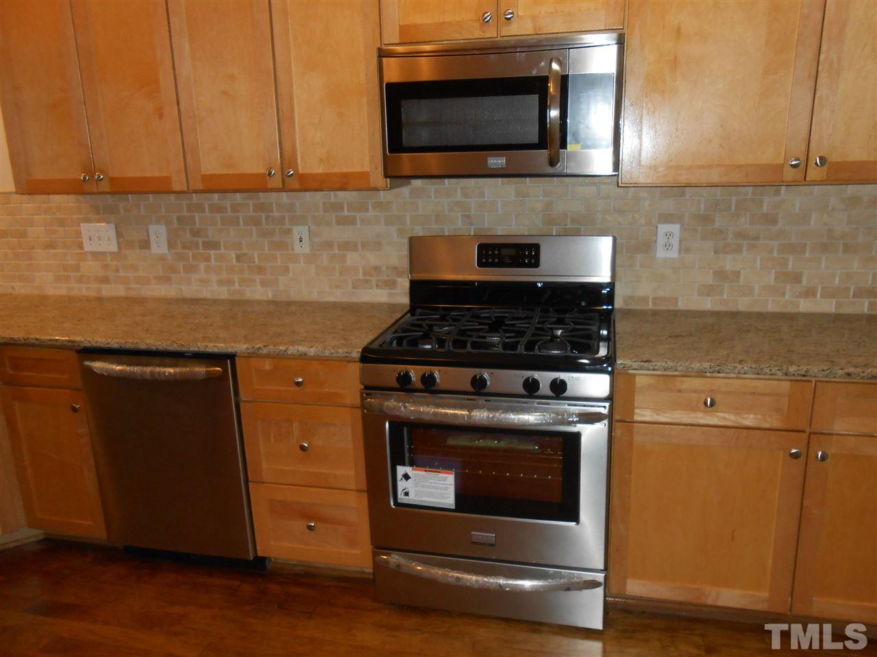 7900 Oneal Road Raleigh, NC 27613 - Photo 9 of 25 a kitchen with a stove and a microwave