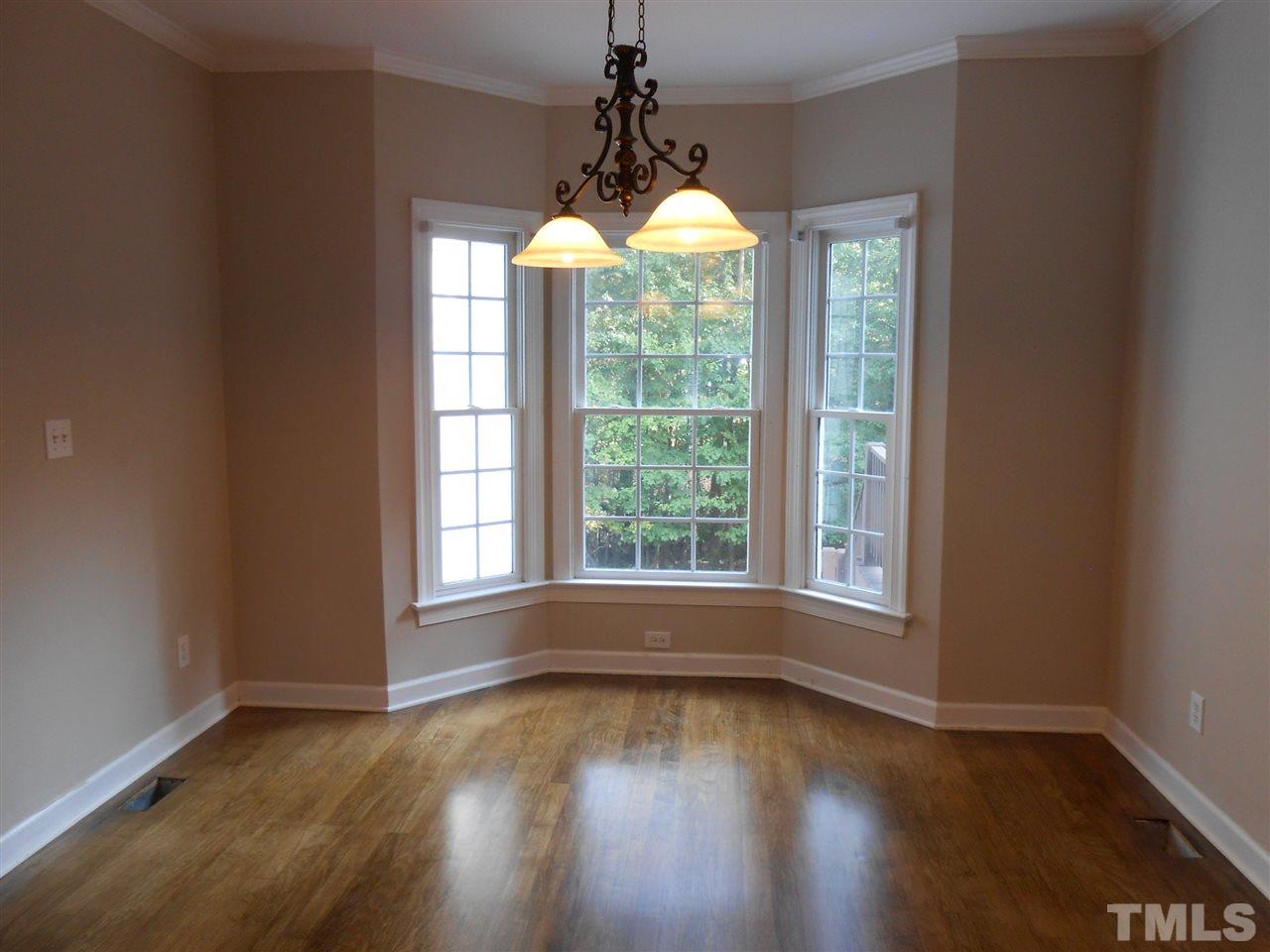 7900 Oneal Road Raleigh, NC 27613 - Photo 10 of 25 a view of empty room with wooden floor and fan
