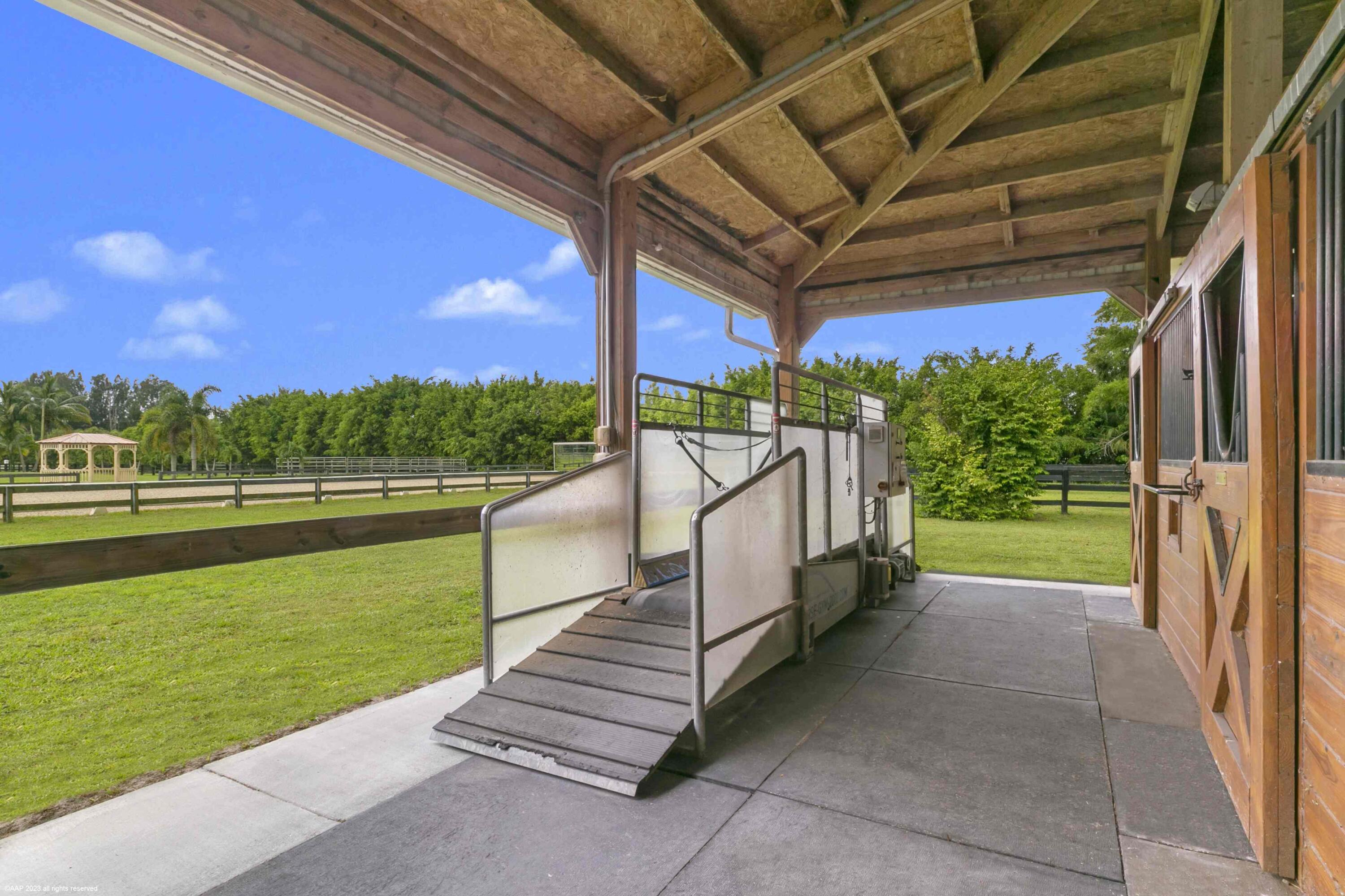 16559 Rustic Road Wellington, FL 33470 - Photo 18 of 82 a view of a porch with a backyard