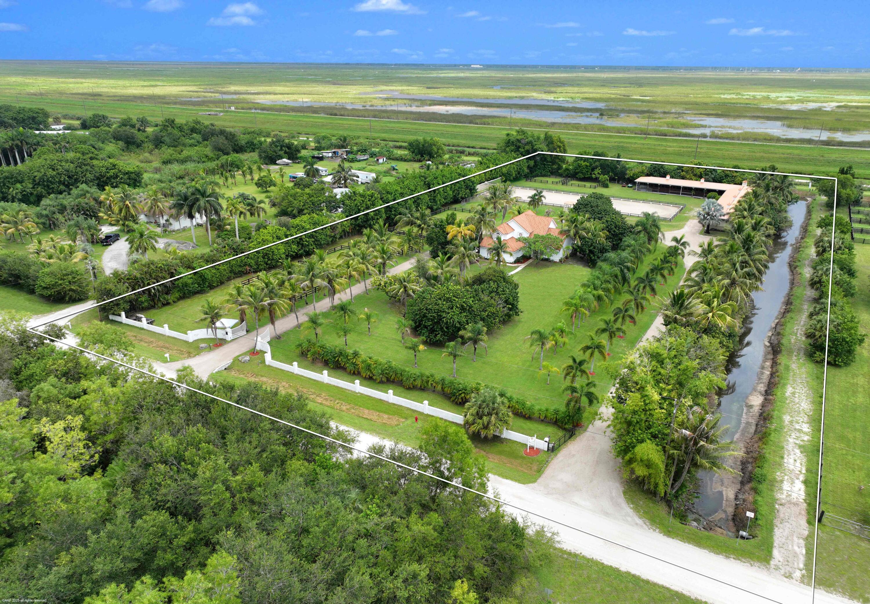 16559 Rustic Road Wellington, FL 33470 - Photo 2 of 82 a view of an ocean and a yard
