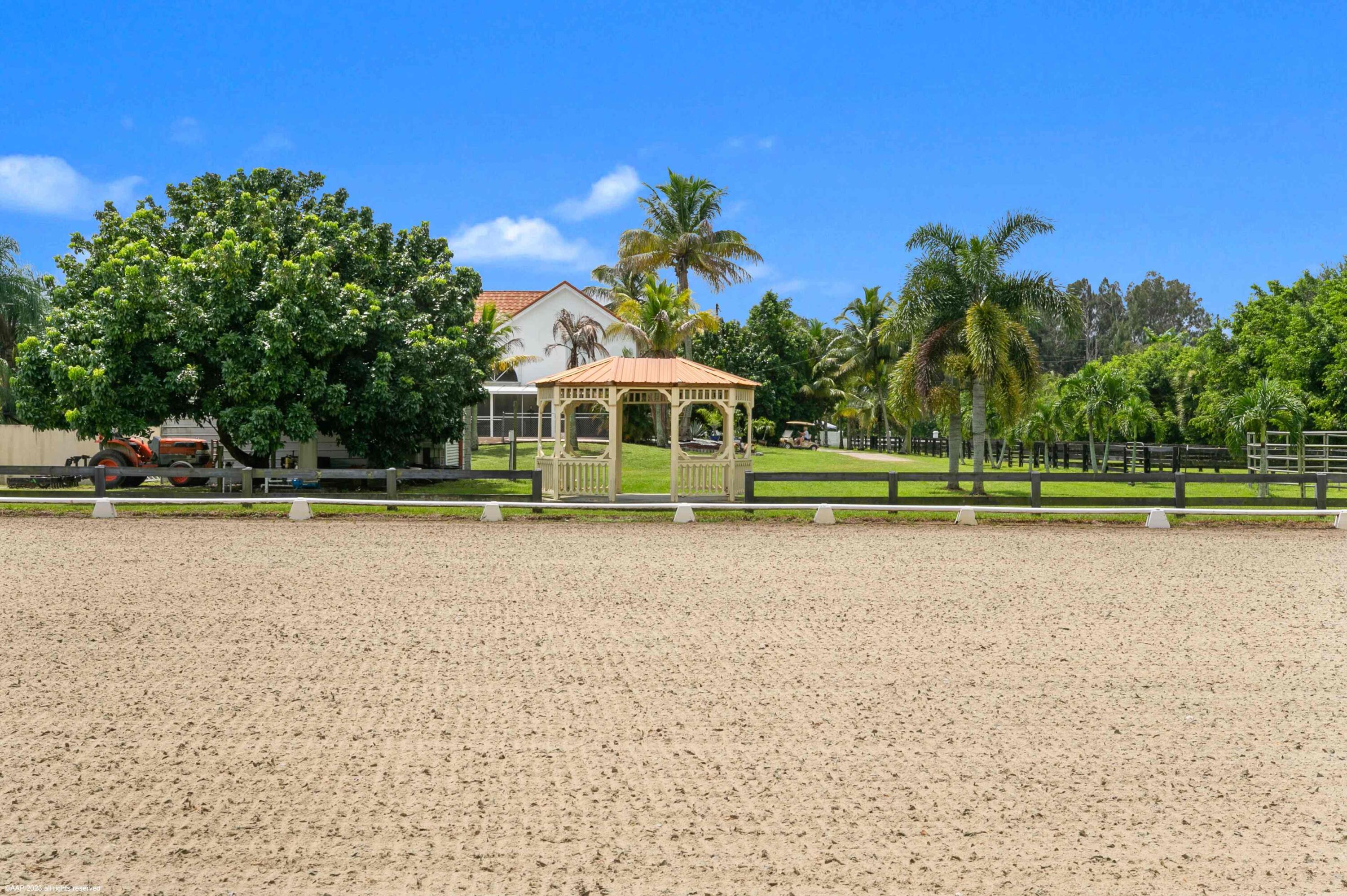 16559 Rustic Road Wellington, FL 33470 - Photo 31 of 82 a view of a house with a yard