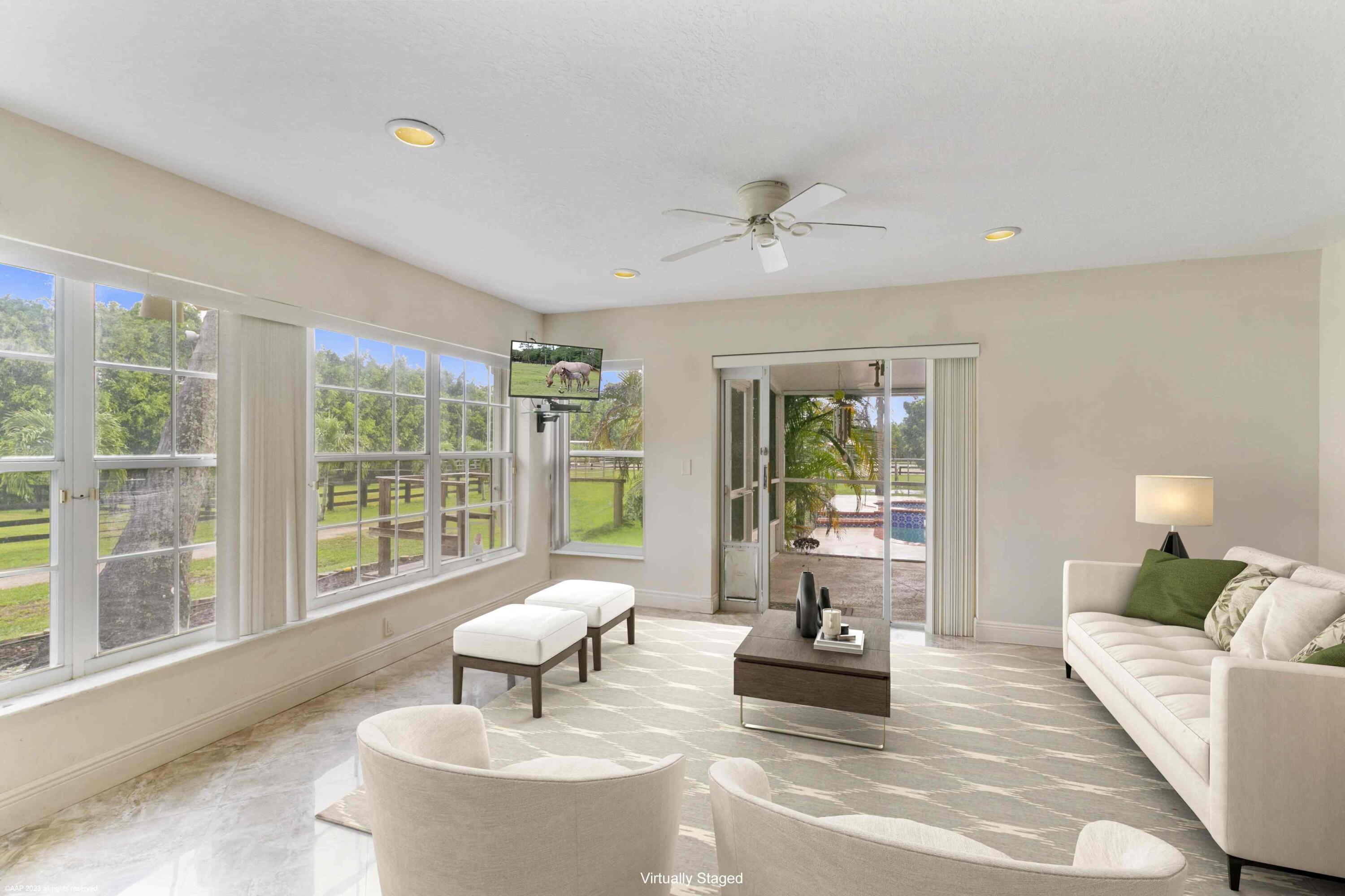 16559 Rustic Road Wellington, FL 33470 - Photo 49 of 82 a living room with furniture and a large window