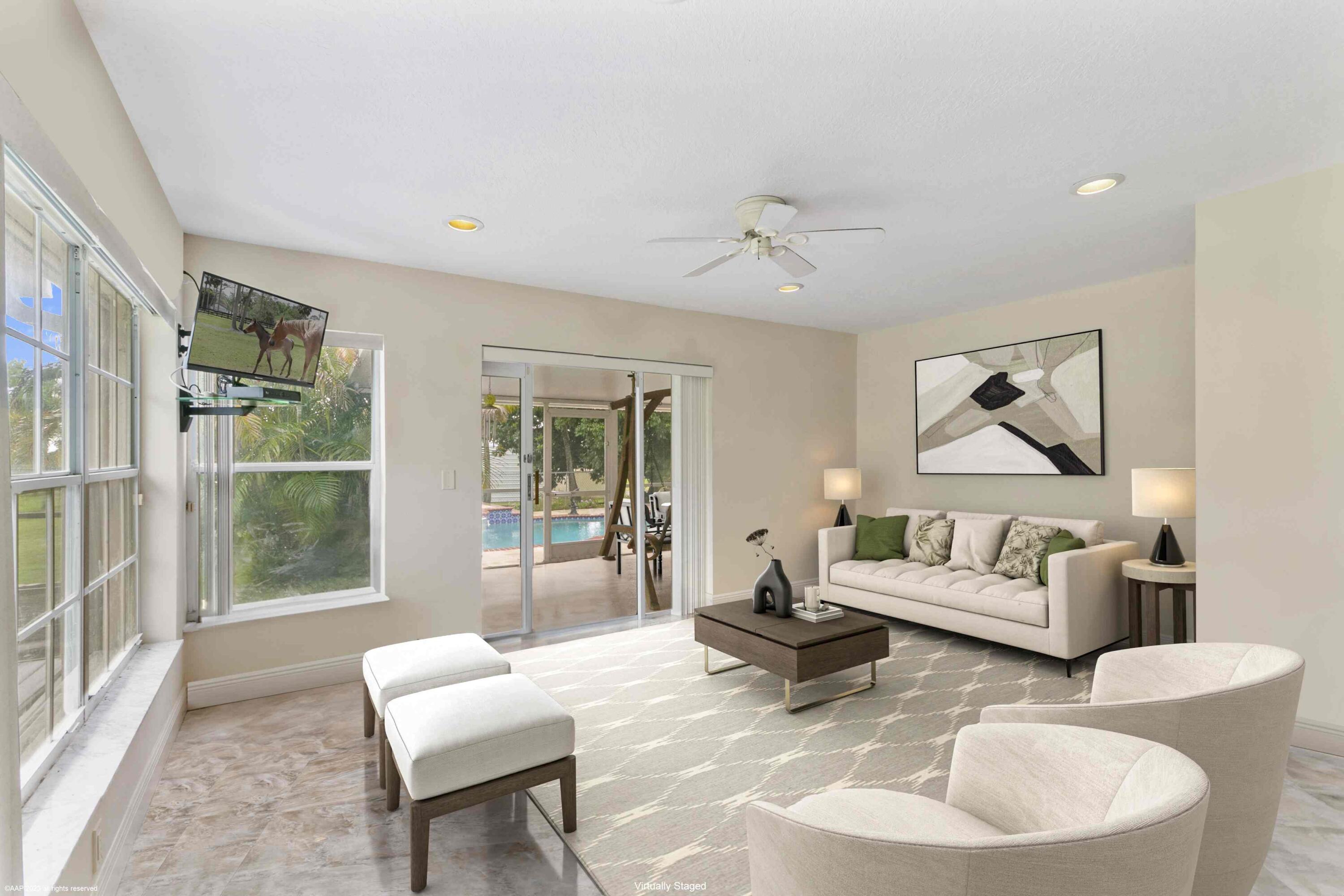 16559 Rustic Road Wellington, FL 33470 - Photo 52 of 82 a living room with furniture and a large window