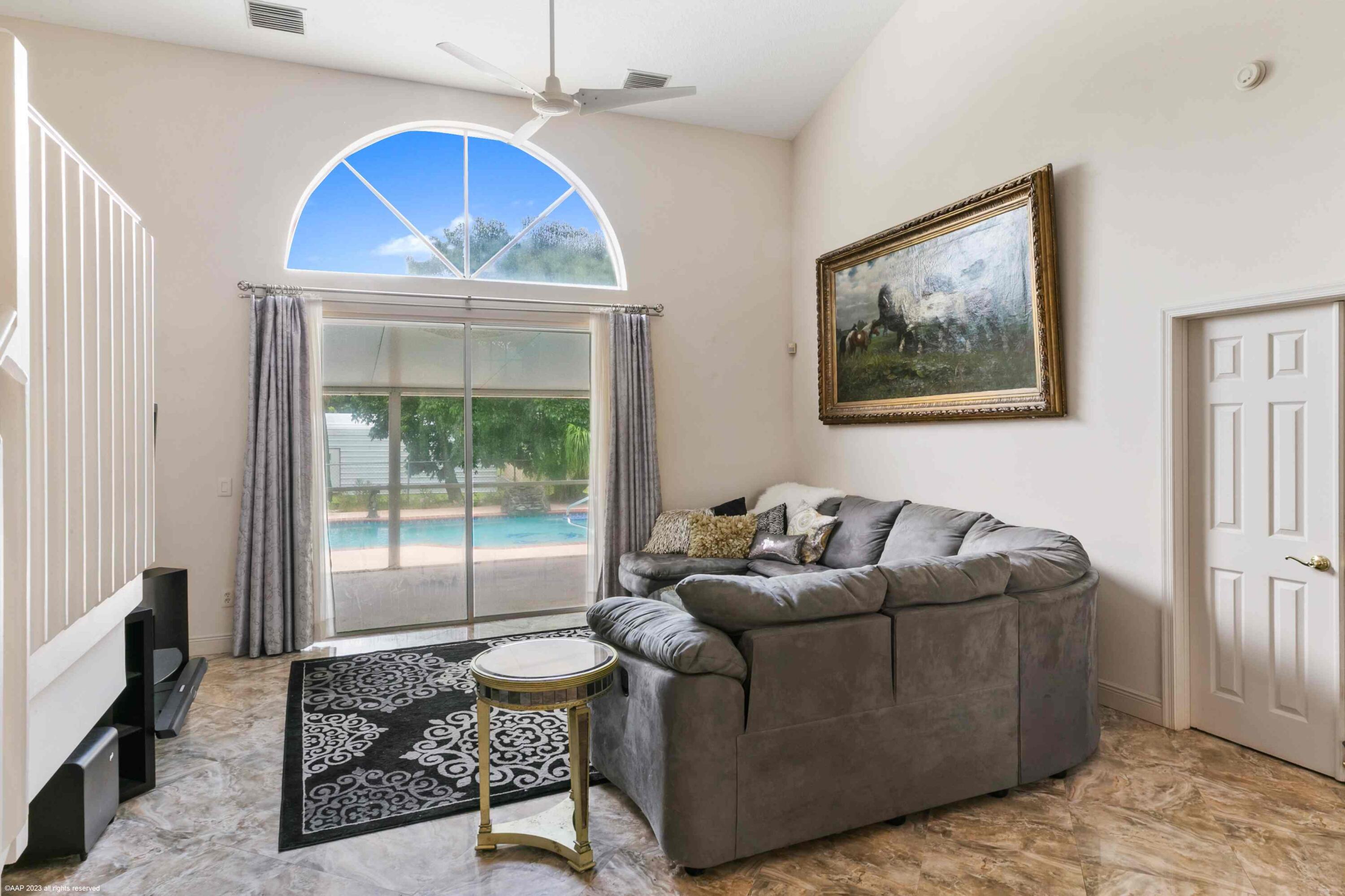 16559 Rustic Road Wellington, FL 33470 - Photo 53 of 82 a living room with furniture and a window