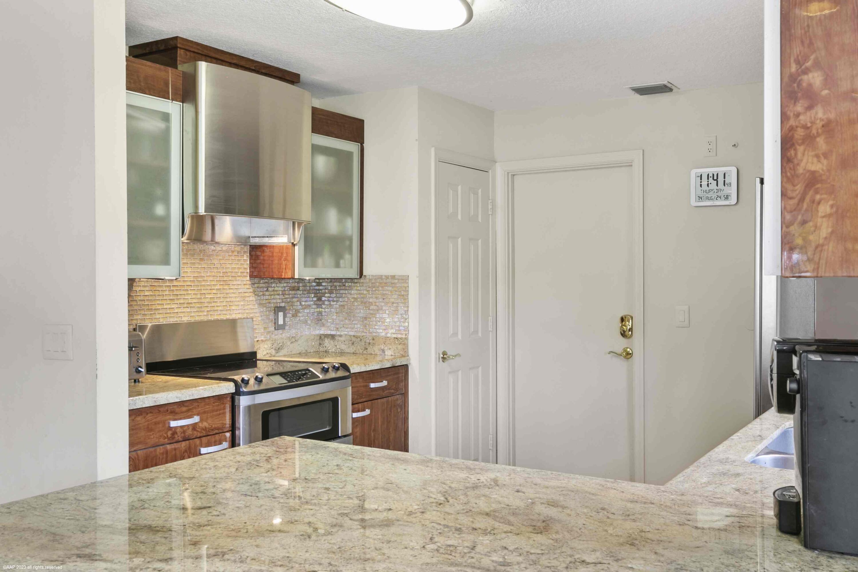 16559 Rustic Road Wellington, FL 33470 - Photo 59 of 82 a kitchen with stainless steel appliances granite countertop a stove and a refrigerator