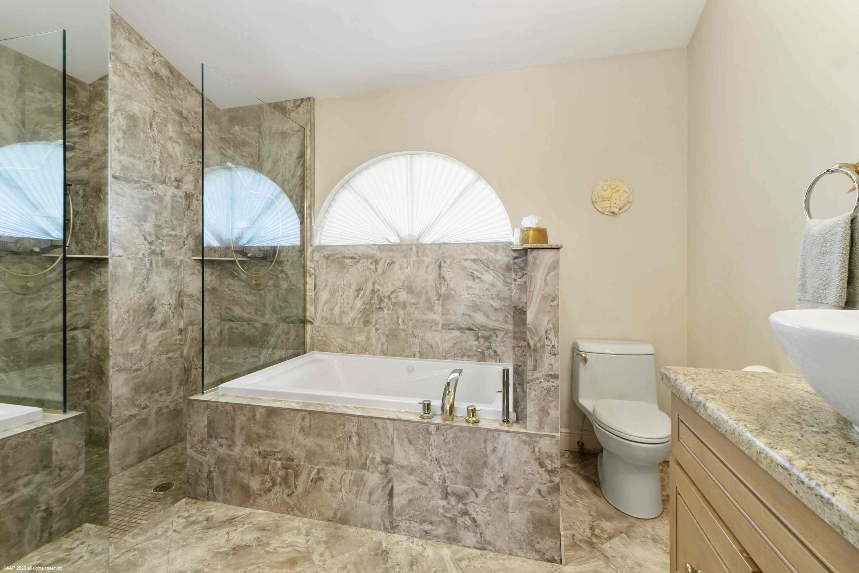 16559 Rustic Road Wellington, FL 33470 - Photo 64 of 82 a bathroom with a granite countertop sink a toilet and shower