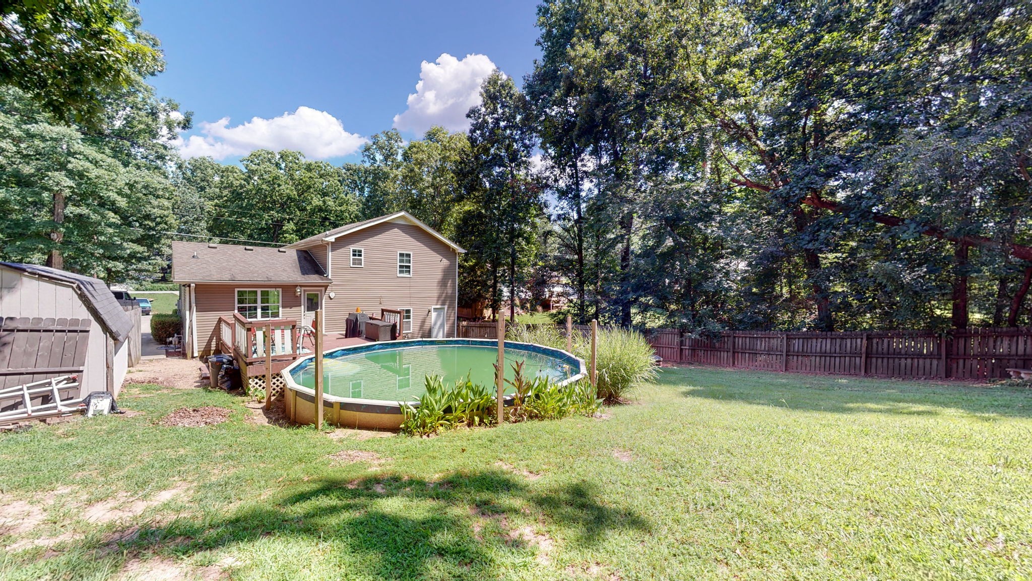 1014 Wildcat Road Dickson, TN 37055 - Photo 26 of 37 a house view with swimming pool and trees in the background