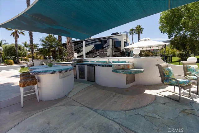 a view of a patio with table and chairs potted plants