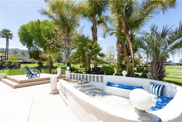 a view of a patio with couches and a fire pit
