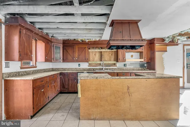 a kitchen with stainless steel appliances granite countertop a sink and cabinets