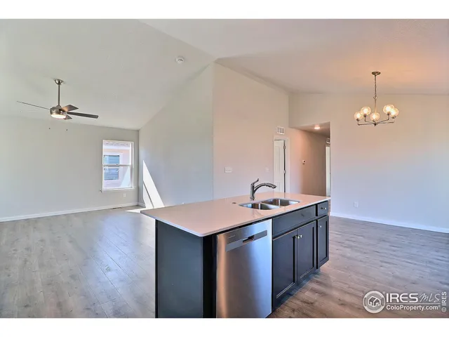 a kitchen with a sink and chandelier