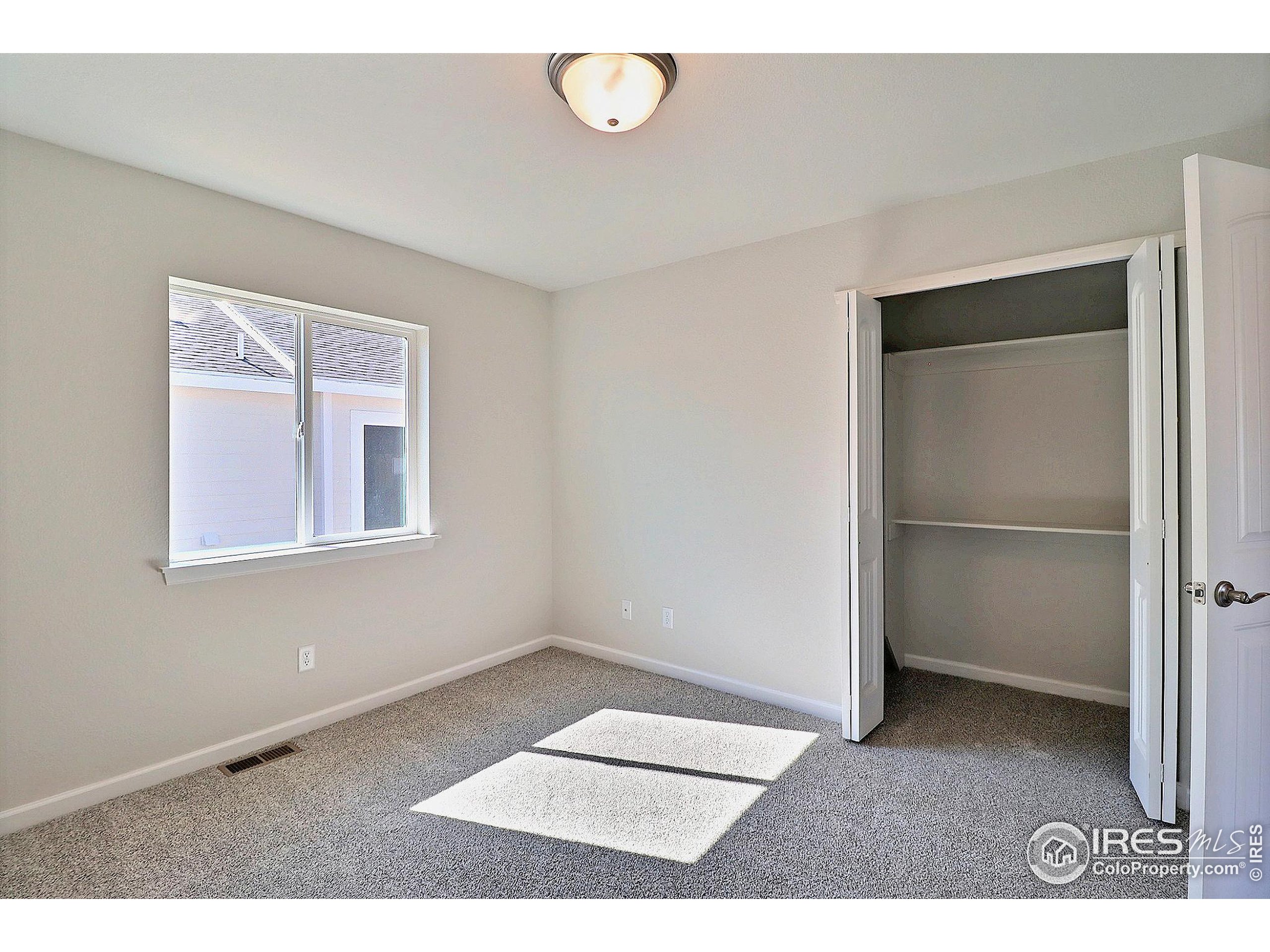 4301 Rockcress Road Evans, CO 80620 - Photo 21 of 26 a view of an empty room with a window