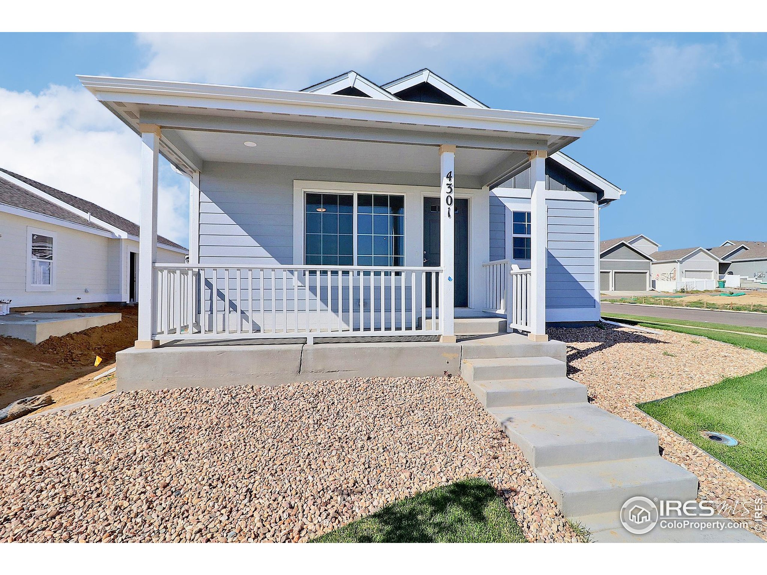 4301 Rockcress Road Evans, CO 80620 - Photo 3 of 26 a front view of a house with a yard and garage