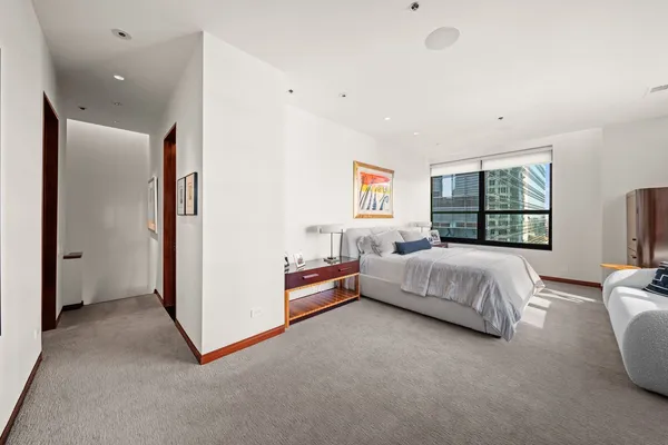 a bed room with a bed and a large window