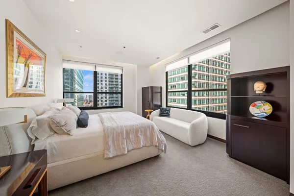a bed room with bed and a large window