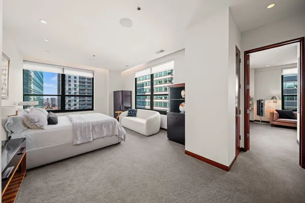 a bed room with a bed and a large window