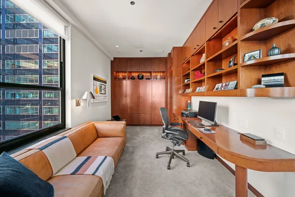 a work room with furniture and book shelf
