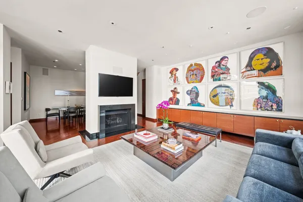 a living room with fireplace furniture and flat screen tv